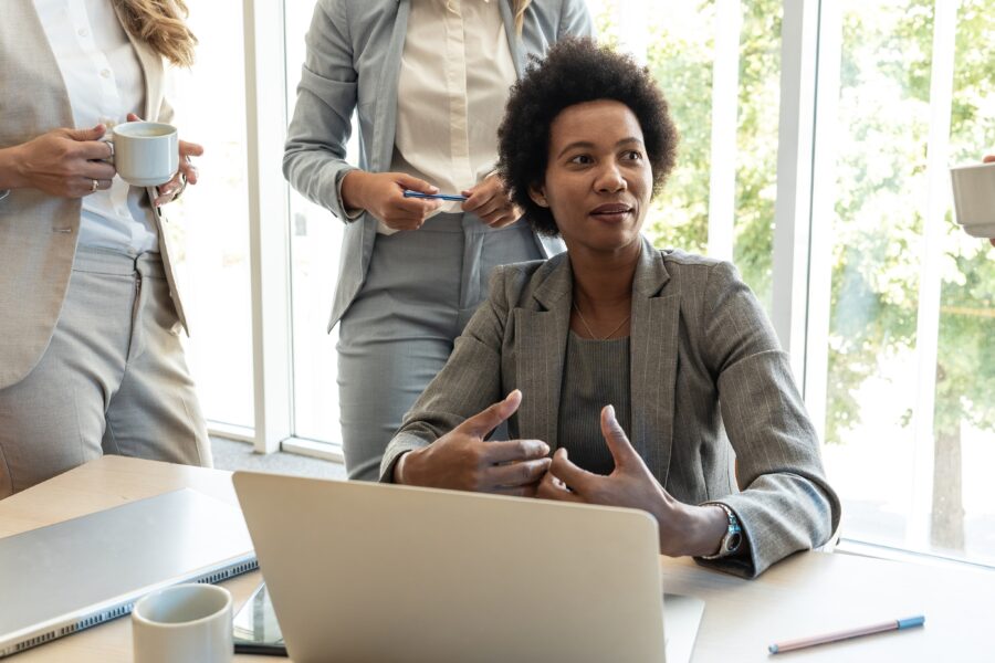 A middle-aged Black businesswoman discussing ideas at the office for a new project.