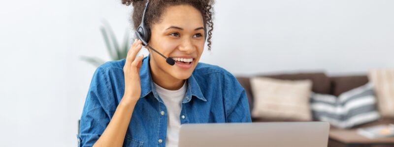 Portrait of happy African American woman employee customer support services or office secretary in headset, online consultation. Call center, customer support or sales female agent