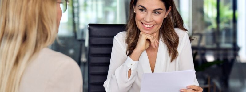 Happy mid aged professional business woman executive hr manager having business discussion with female employee