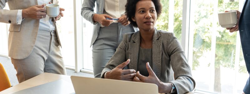 A middle-aged Black businesswoman discussing ideas at the office for a new project.